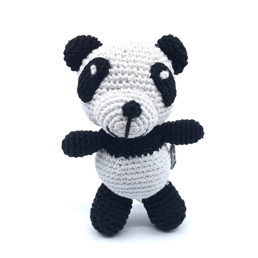 Crochet panda toy with white body, black ears and limbs, stitched smile and snout.