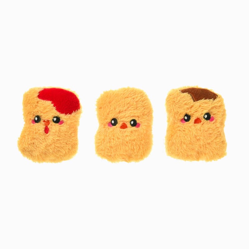 Three mini chicken nugget plush dog toys with smiling faces in yellow and red