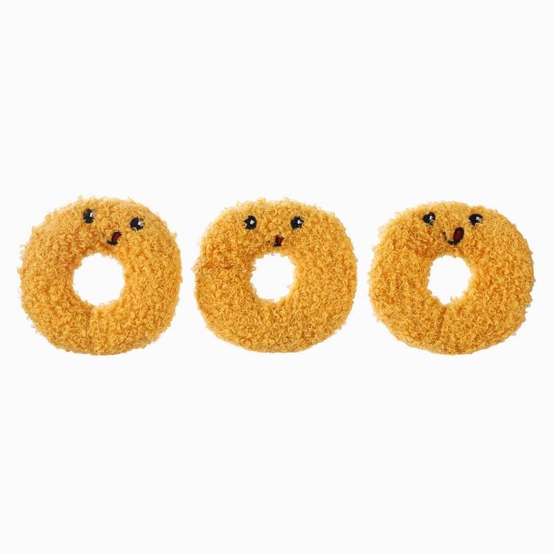 Three tan curly plush ring toys with stitched faces