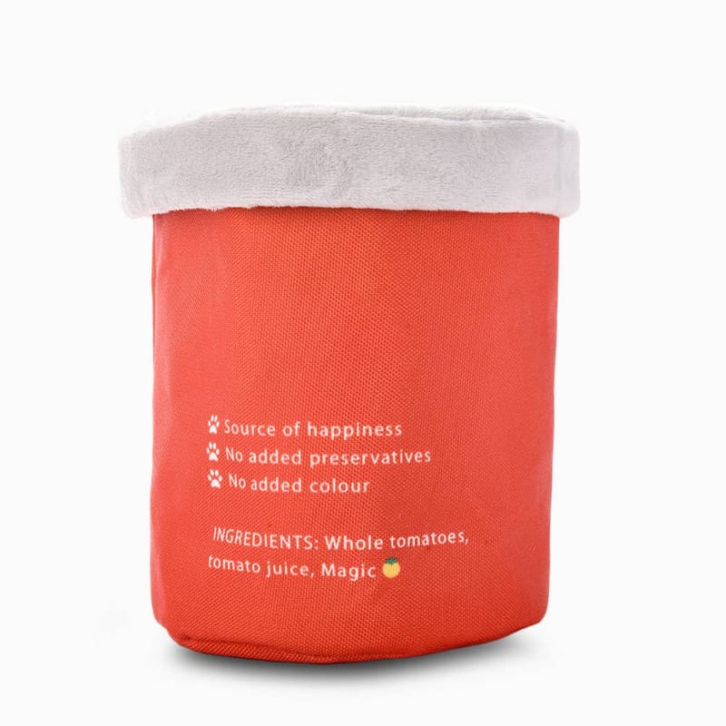 Plush tomato can dog toy back with ingredient-style text and paw icon