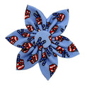 Blue pinwheel dog collar bow with patriotic paw and candy-cane pattern