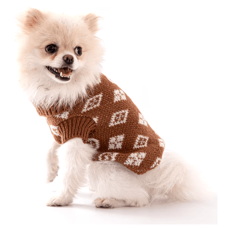 Dog wearing brown knit turtleneck sweater with white diamond and heart pattern