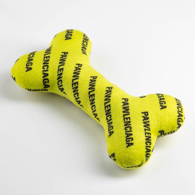Neon yellow plush bone dog toy with Pawlenciaga logo print, angled side view