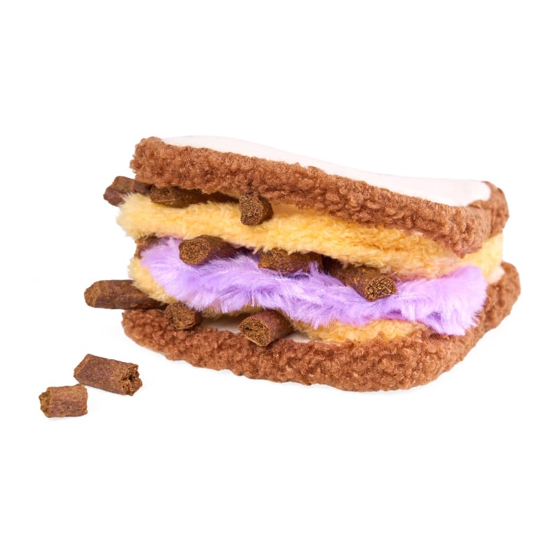 Layered plush sandwich dog toy with brown crust, yellow filling, purple middle and crumbs