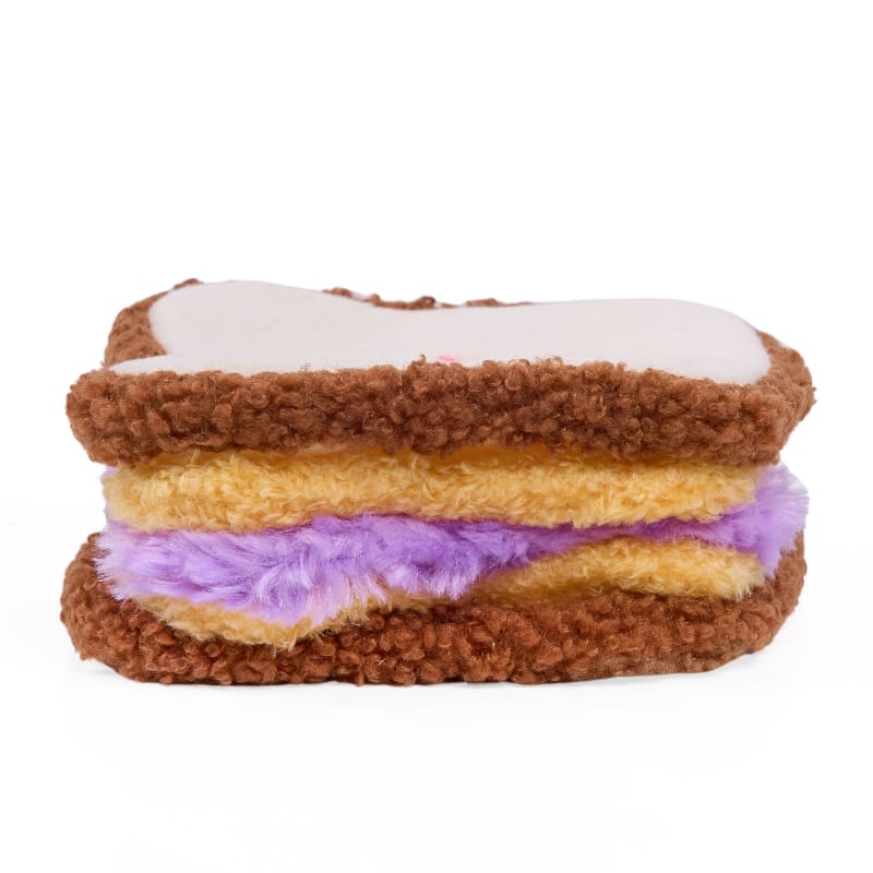 Stacked plush sandwich dog toy with brown bread, yellow and purple layers, fluffy top