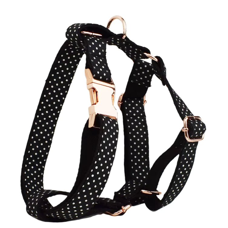 Black polka dot dog harness with rose-gold fasteners and straps