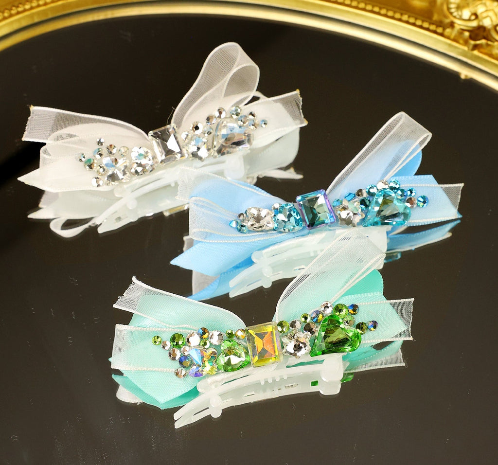 Crystal ribbon hair clips with bow accents, in white, blue, and green with rhinestones