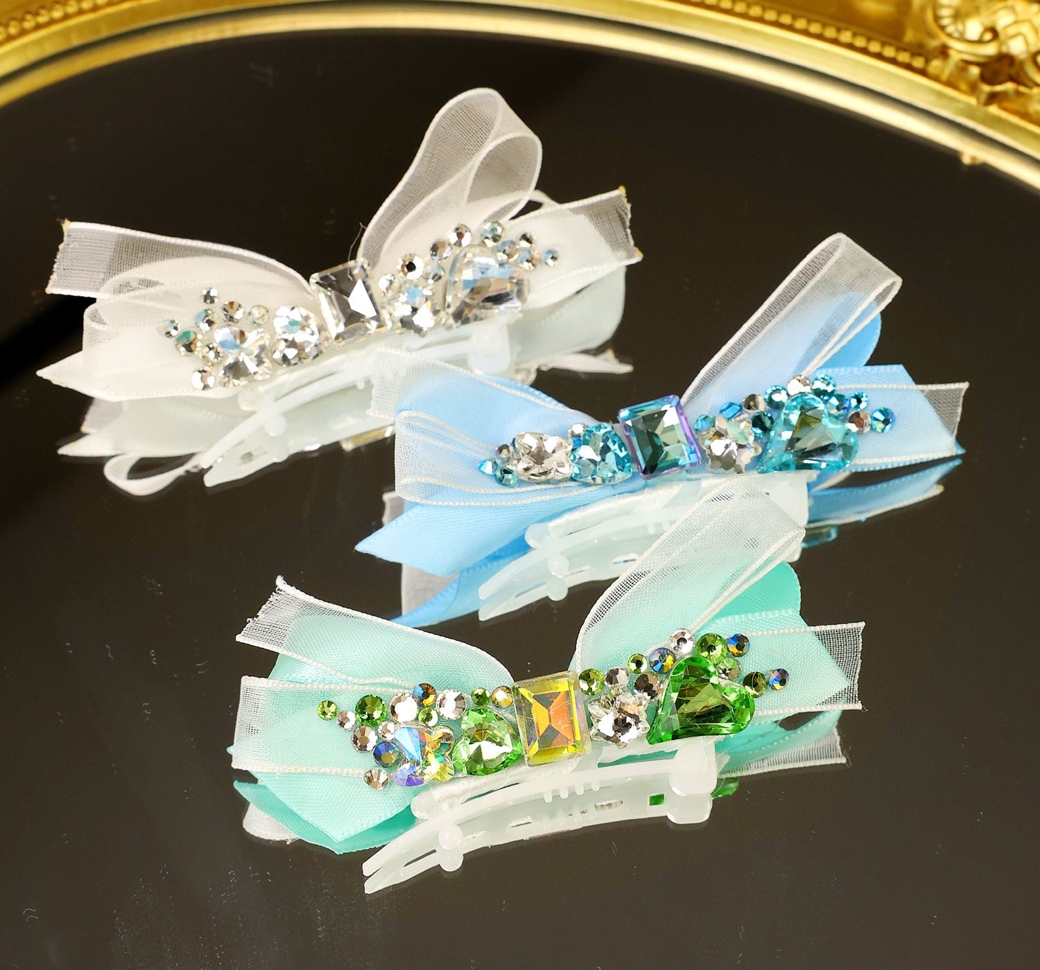 Crystal ribbon hair clips with bow accents, in white, blue, and green with rhinestones