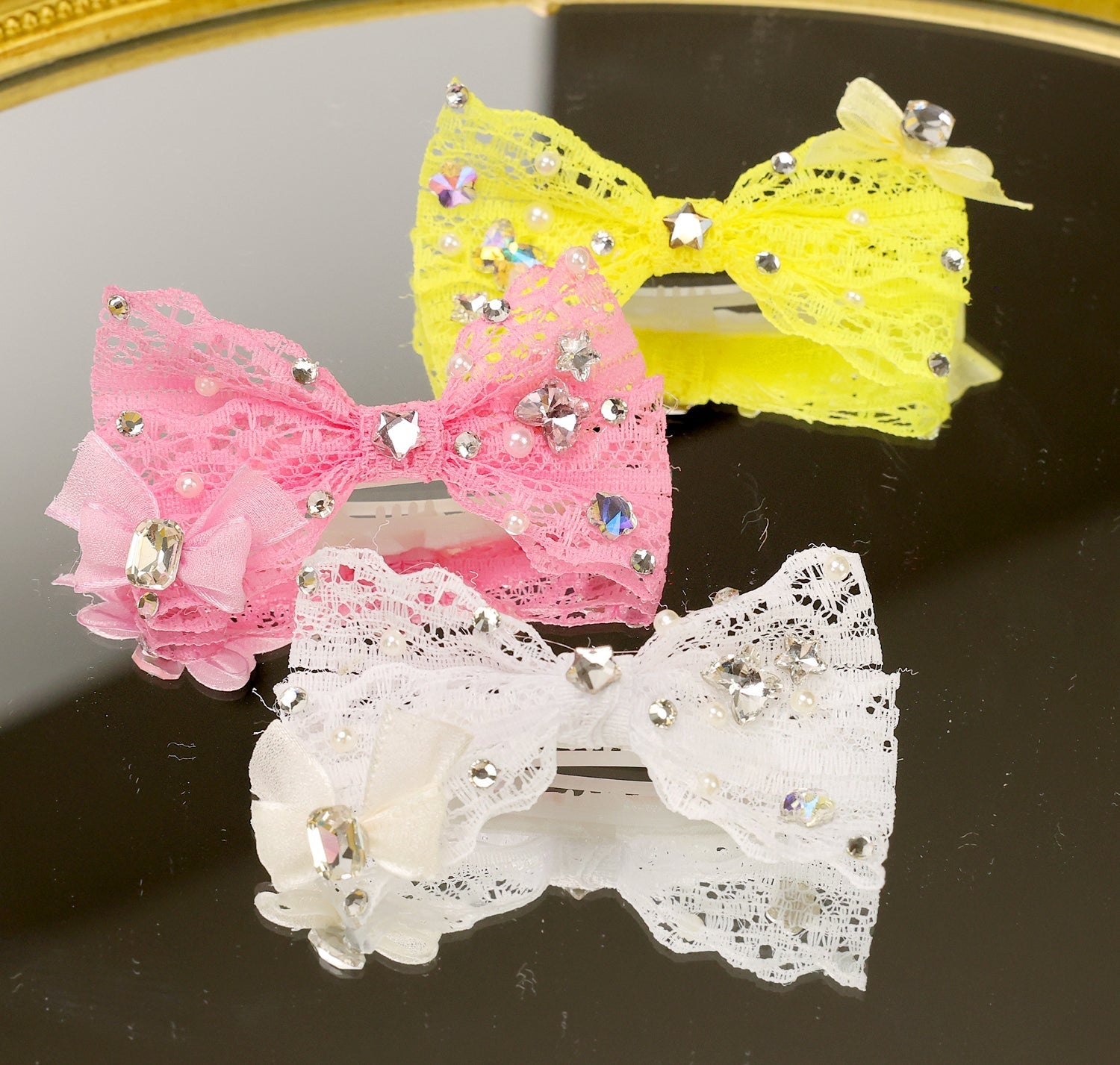 Lace rhinestone bow hair clips with layered bows in pink, yellow, and white