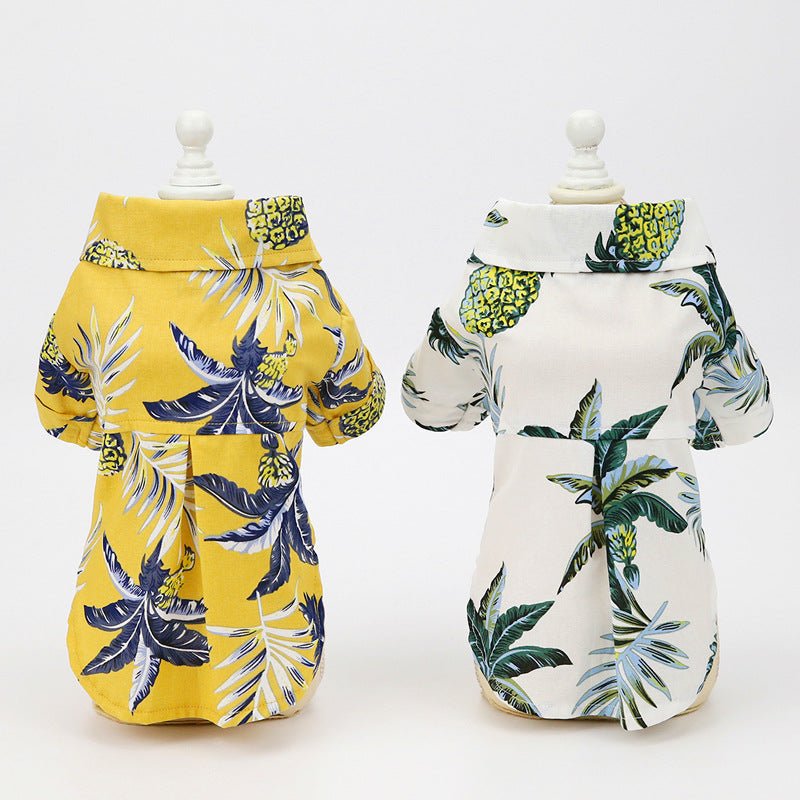 Two tropical-print dog summer shirts on mannequins: yellow and white