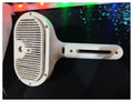 Close-up of white pet dematting comb brush head with metal teeth and mist vent