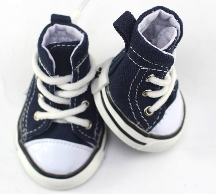 Navy blue canvas dog sneakers with white laces and cushioned ankle collar