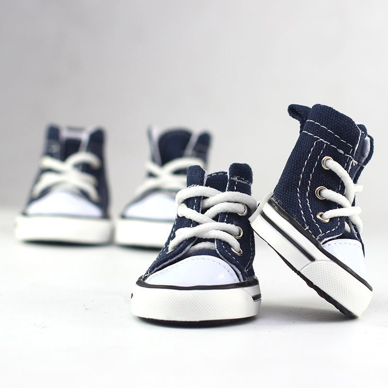 Navy blue canvas cowboy-style dog shoes with white laces and side stripes