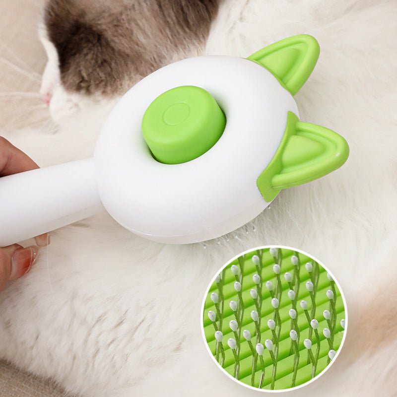 Self-cleaning pet grooming brush with green bristle pad and rounded cleaning button on cat fur