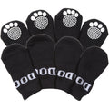 Set of black pet dog socks with white paw-print grippers on the toes