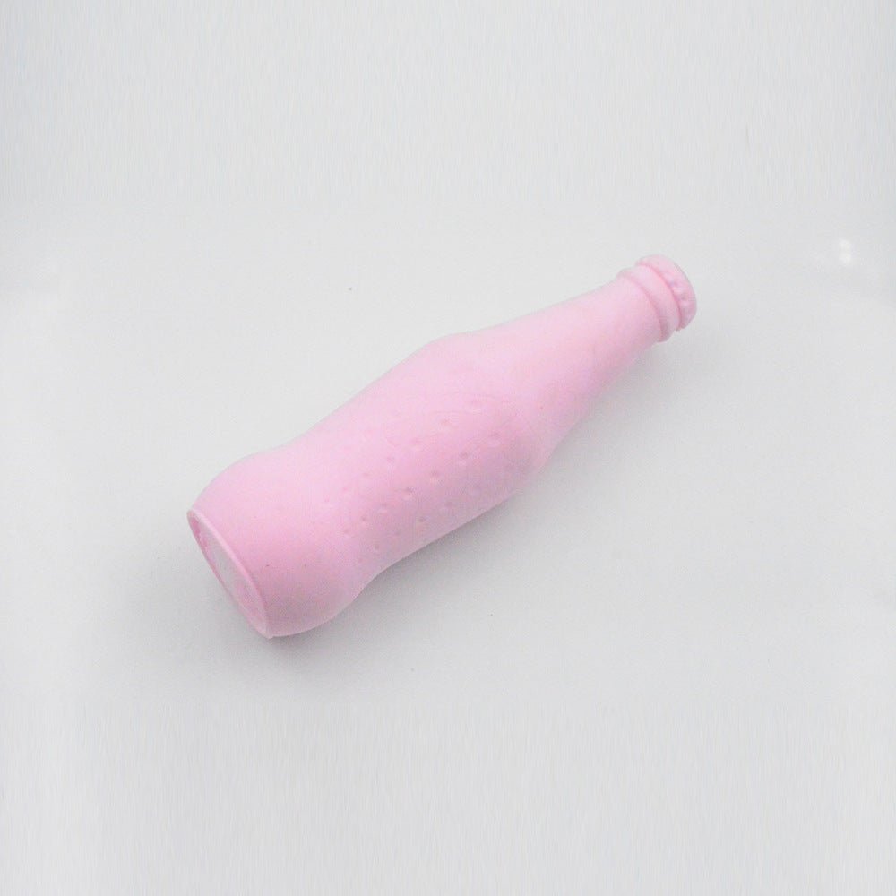 Pink bottle-shaped pet teeth-cleaning chew toy with small textured bumps