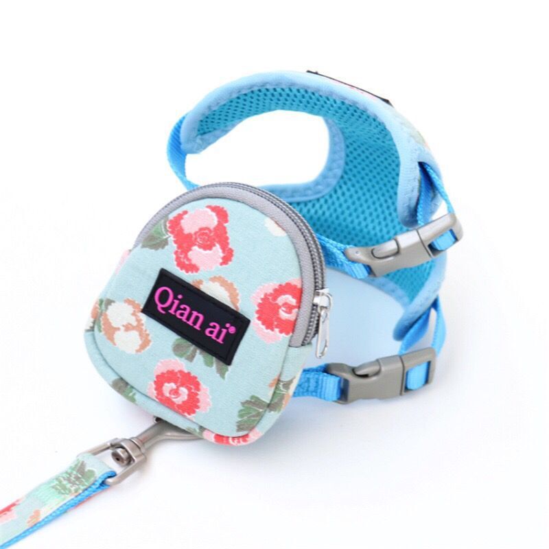 Blue pet harness vest with light blue floral zipper pouch, adjustable metal buckles