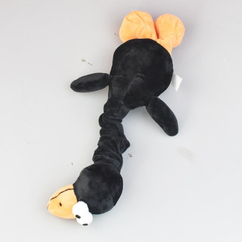 Black bite-resistant dog plush toy with orange ears and a long body