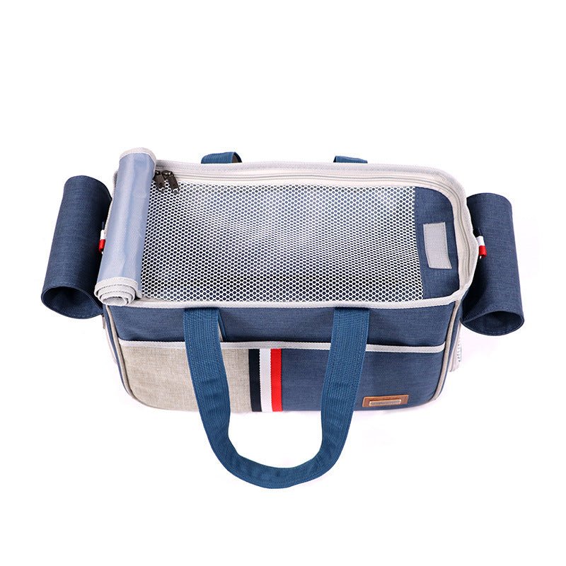 Top view of foldable pet carrier tote with navy trim, light gray mesh panel, and side handles