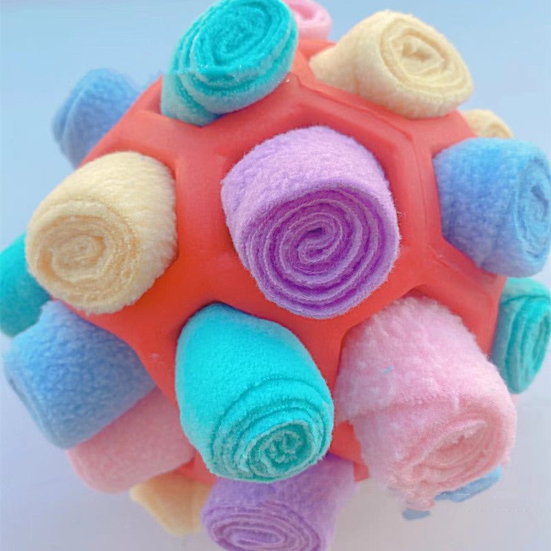 Dog sniffing plush ball toy with pastel multicolor woven spheres and soft rounded shapes