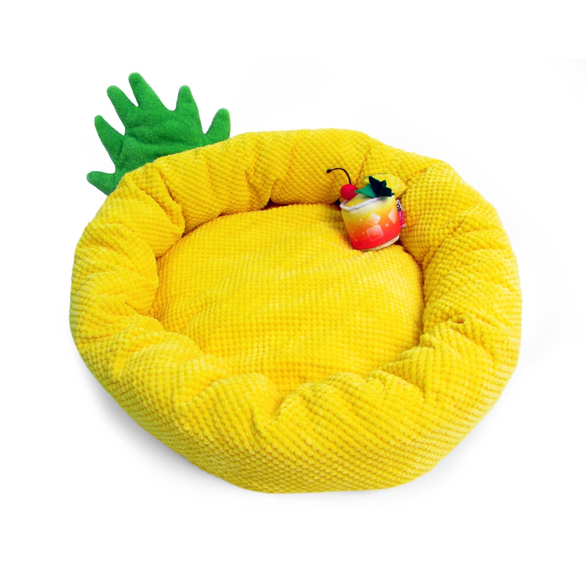 Pineapple-shaped pet bed with yellow plush and green spiky rim, with cocktail toy