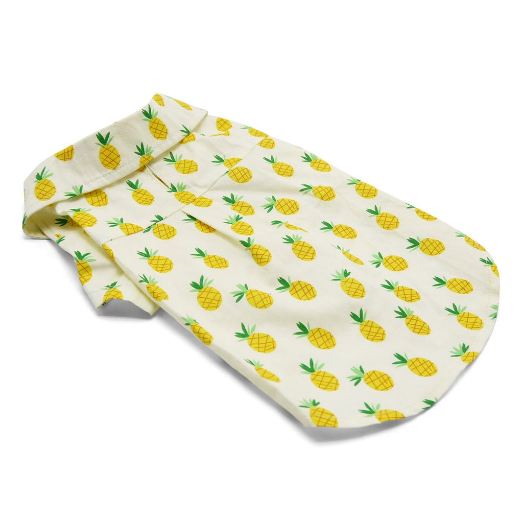 Pet shirt with pineapple print, laid flat with white base and yellow-green pineapple pattern