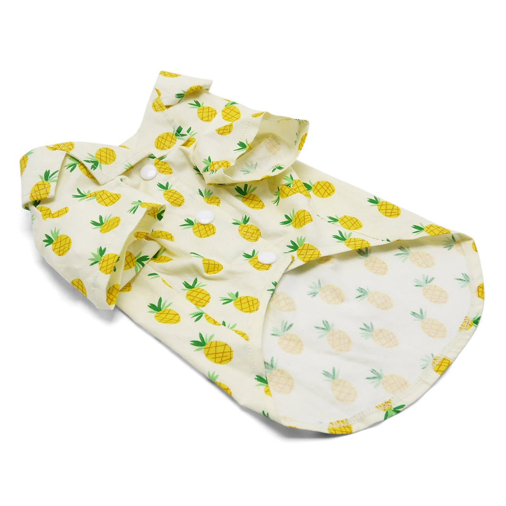 Pet shirt with pineapple print, folded front view in white with yellow pineapple and green leaf