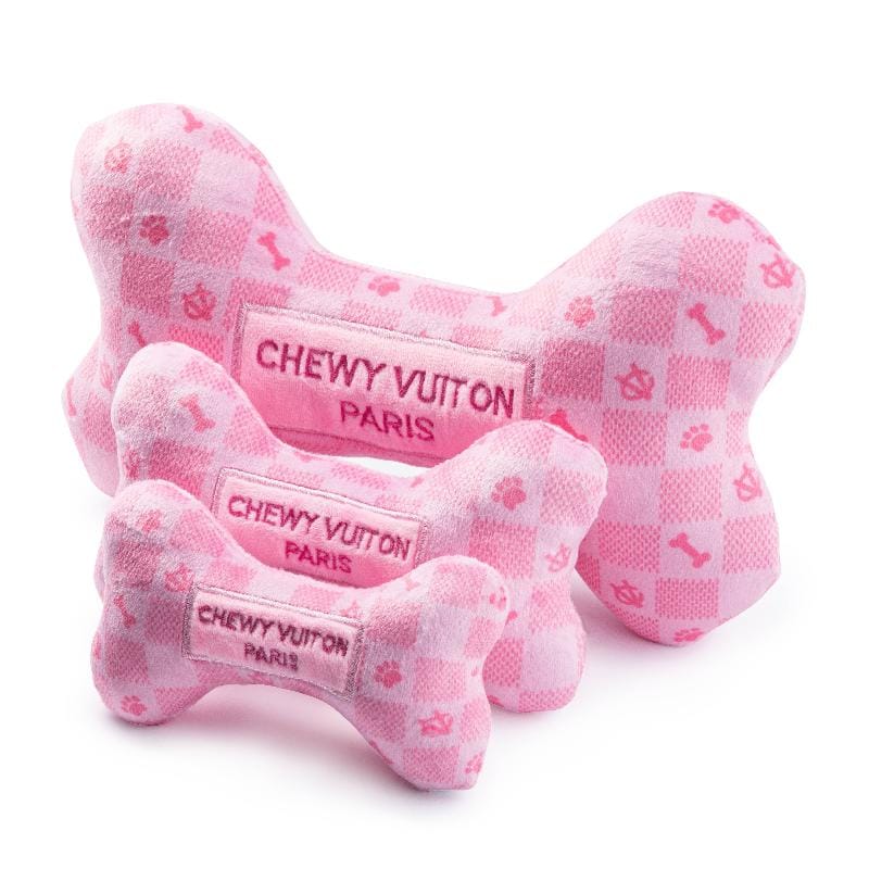 Pink plush dog bone toy with checker pattern and three stitched “CHEWY VUITON PARIS” tags