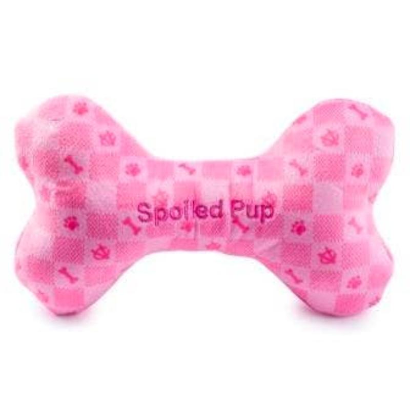 Pink plush dog bone toy with checker pattern and embroidered “Spotted Pup” text