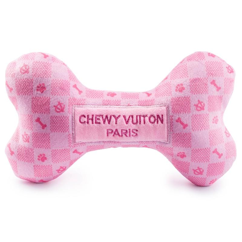 Pink plush dog bone toy with checker pattern and centered stitched “CHEWY VUITON PARIS” label