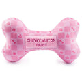 Pink plush dog bone toy with checker pattern and centered stitched “CHEWY VUITON PARIS” label