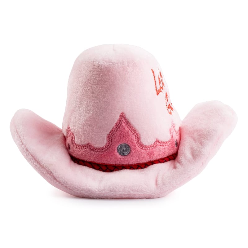 Pink plush cowgirl hat dog toy with stitched red panel and round dark button detail