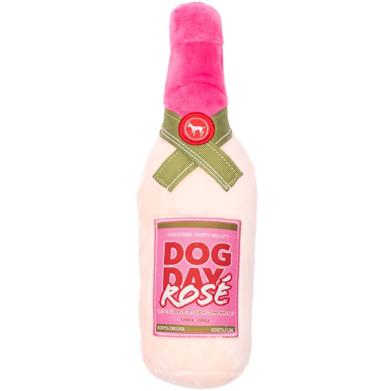 Plush bottle-shaped dog toy with pink top, green ribbon, and DOG DAY ROSE label