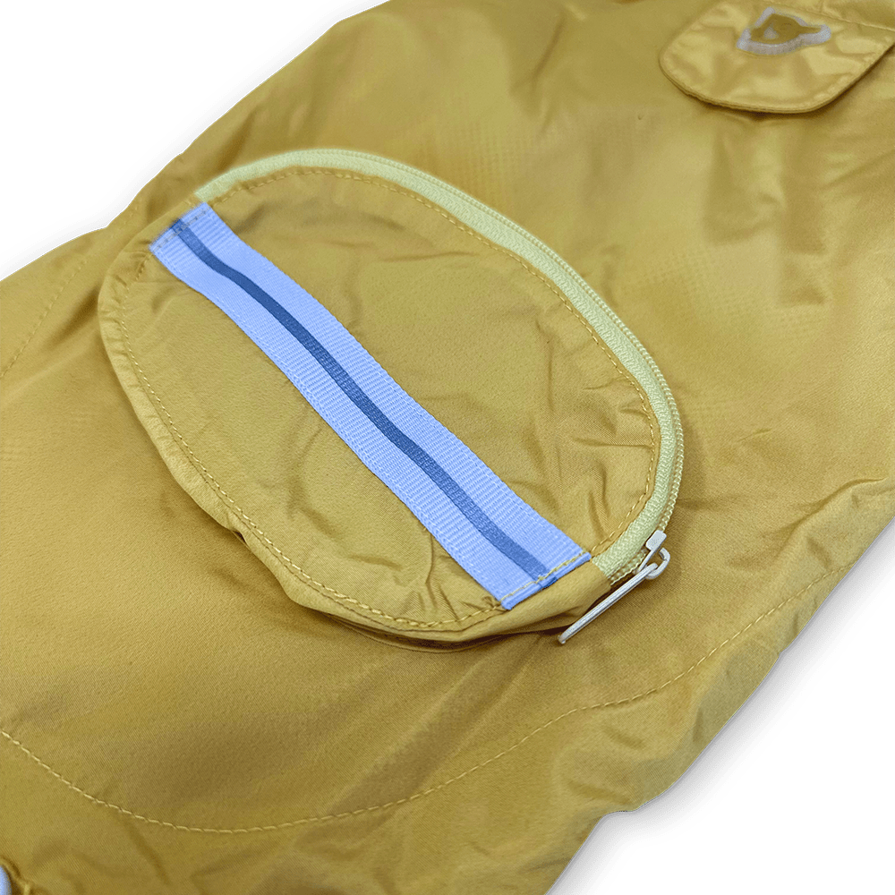 Yellow raincoat close-up of oval front pocket with blue reflective stripe