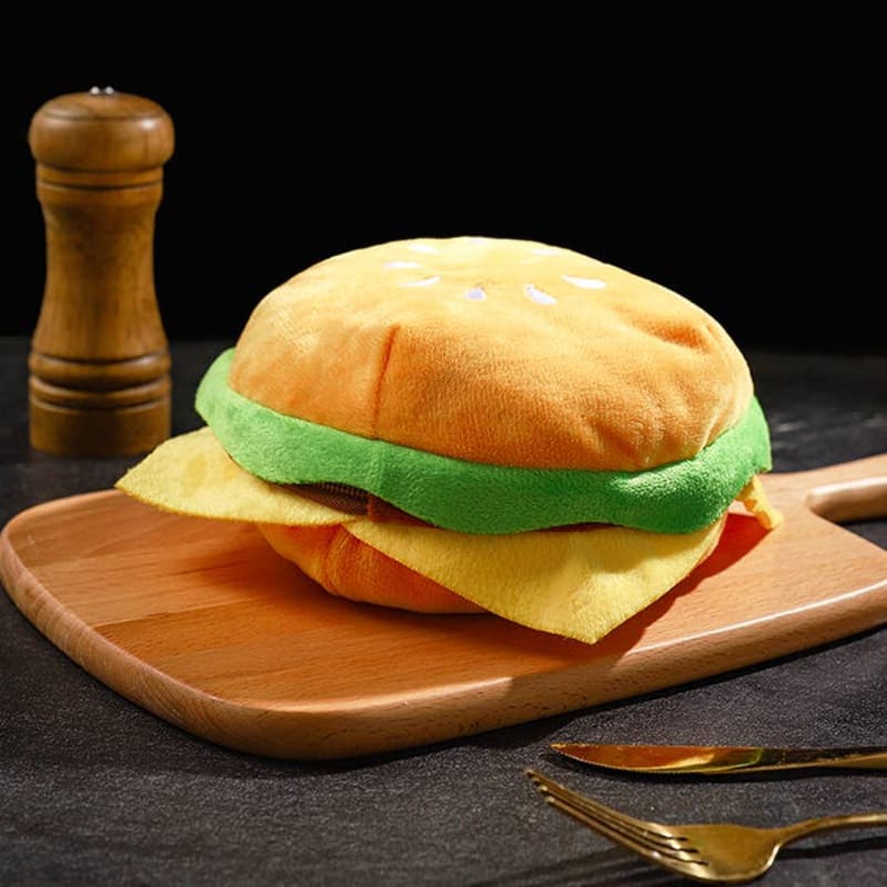 Cheeseburger-shaped plush dog backpack with green lettuce and yellow bun layers