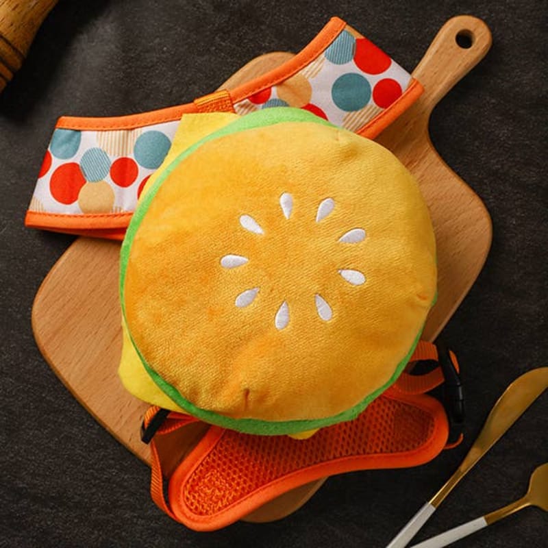 Cheeseburger plush dog backpack with orange-and-yellow pouch and multi-color side panel straps