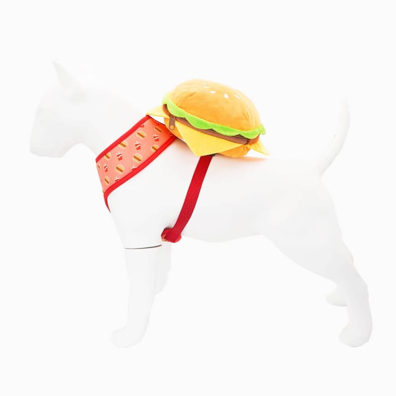 Cheeseburger-shaped plush dog backpack with red side strap and green-and-yellow top