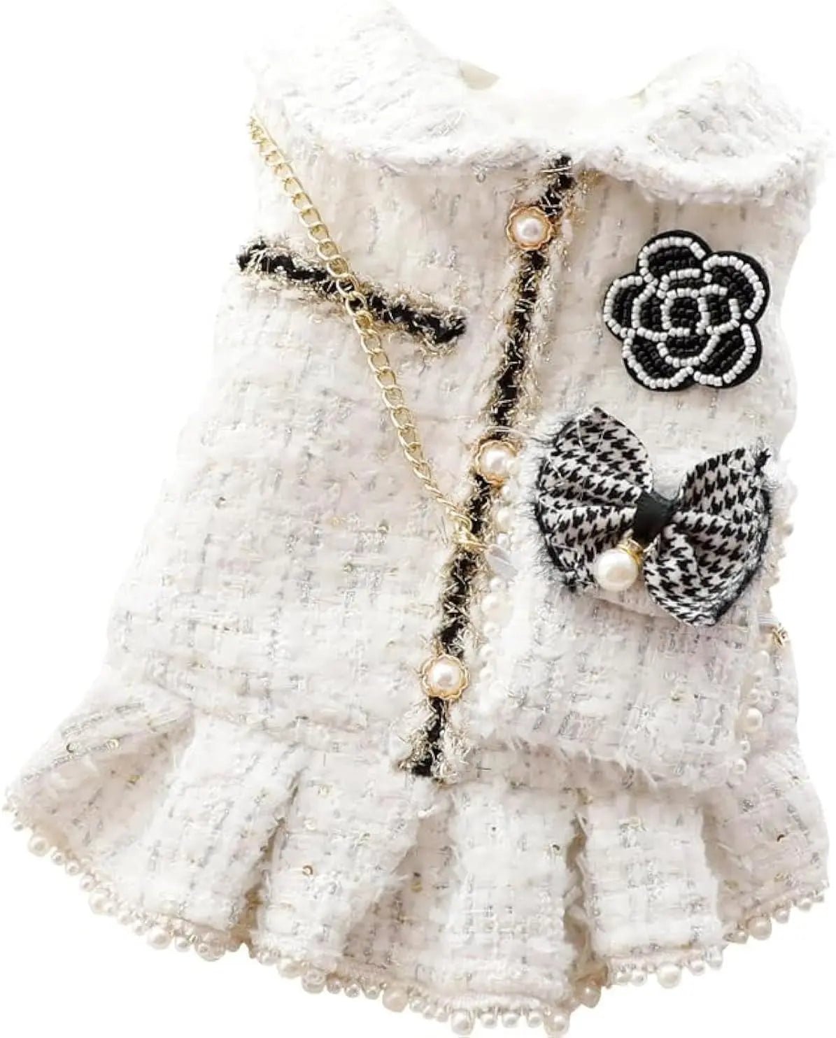 White tweed dog dress with flower badge, gold chain, pearl accents, and check bow