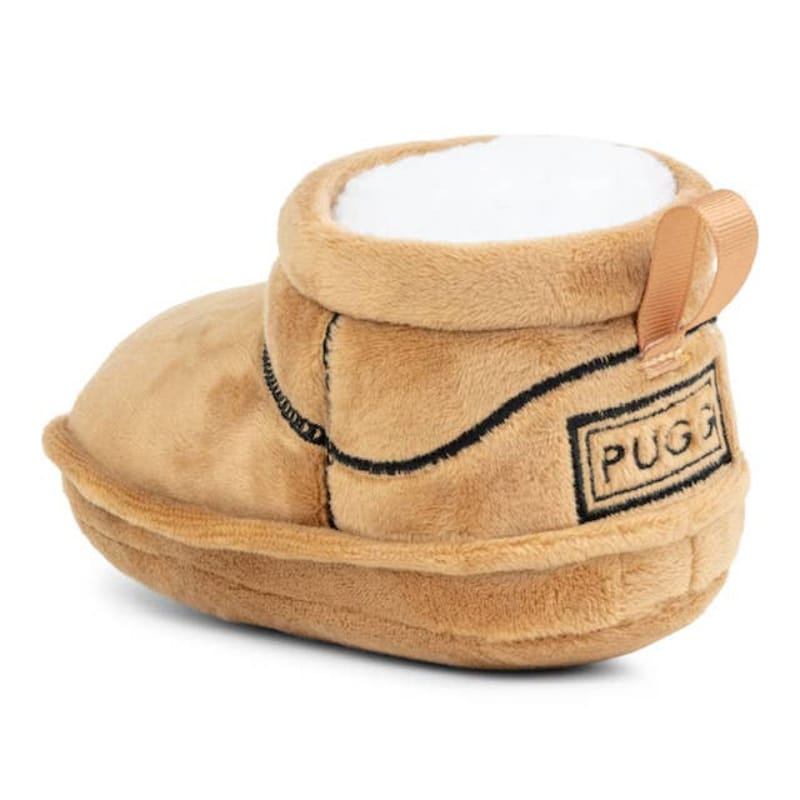 Tan plush boot dog toy with white lining and 'PUG' logo patch