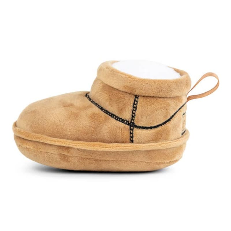 Tan plush dog boot toy with fabric handle and black stitched trim