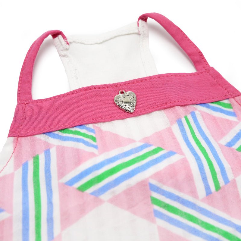 Close-up of pink pet dress neckline with small heart button detail