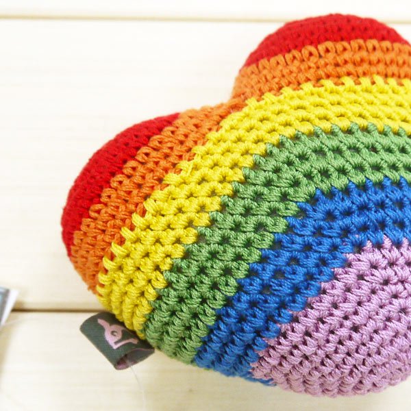 Rainbow striped crochet heart toy close-up of multicolor crocheted bands and texture