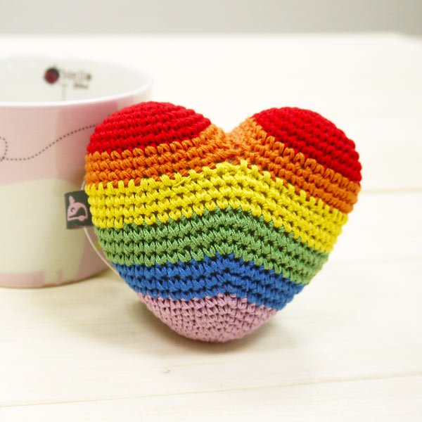 Rainbow striped crochet heart toy, multicolor bands and stitched surface with tag