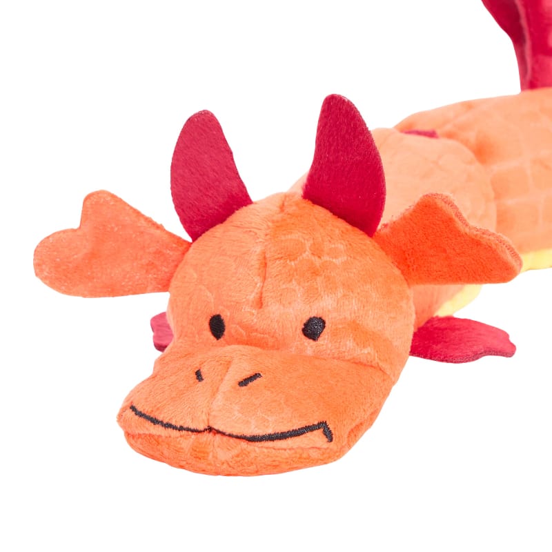 Orange plush dragon dog toy face with red horns, smile stitching, and dark eyes