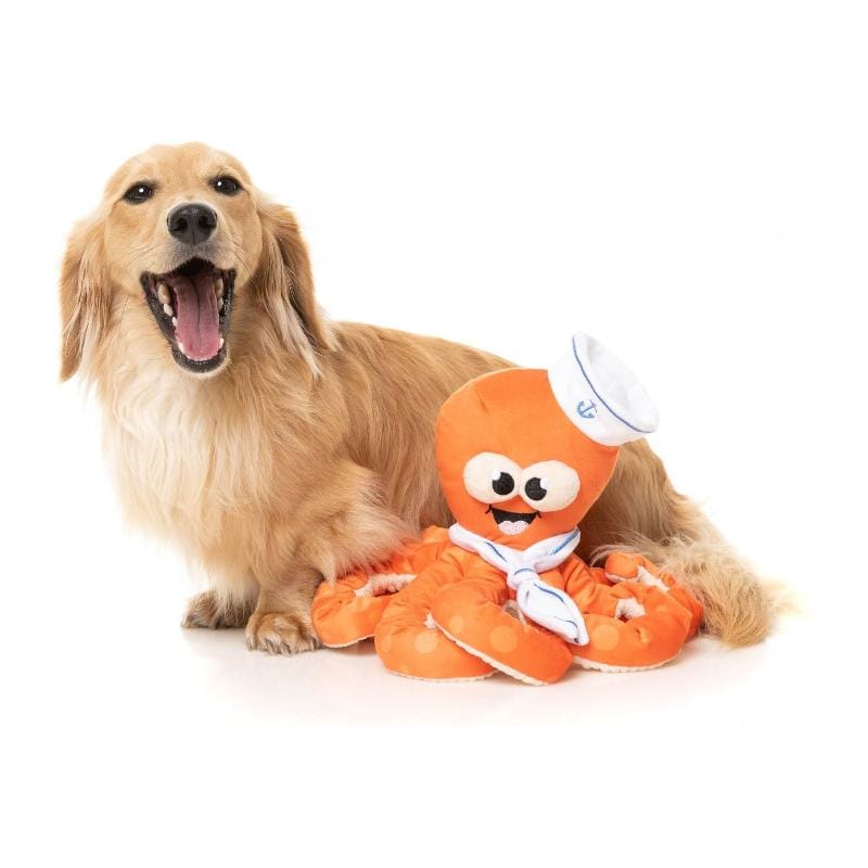Orange octopus plush dog toy with white sailor cap and blue trim, posed flat