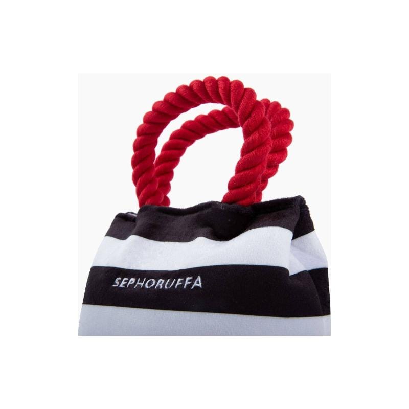 Red rope handle plush shopping-bag dog toy with black-and-white stripe body