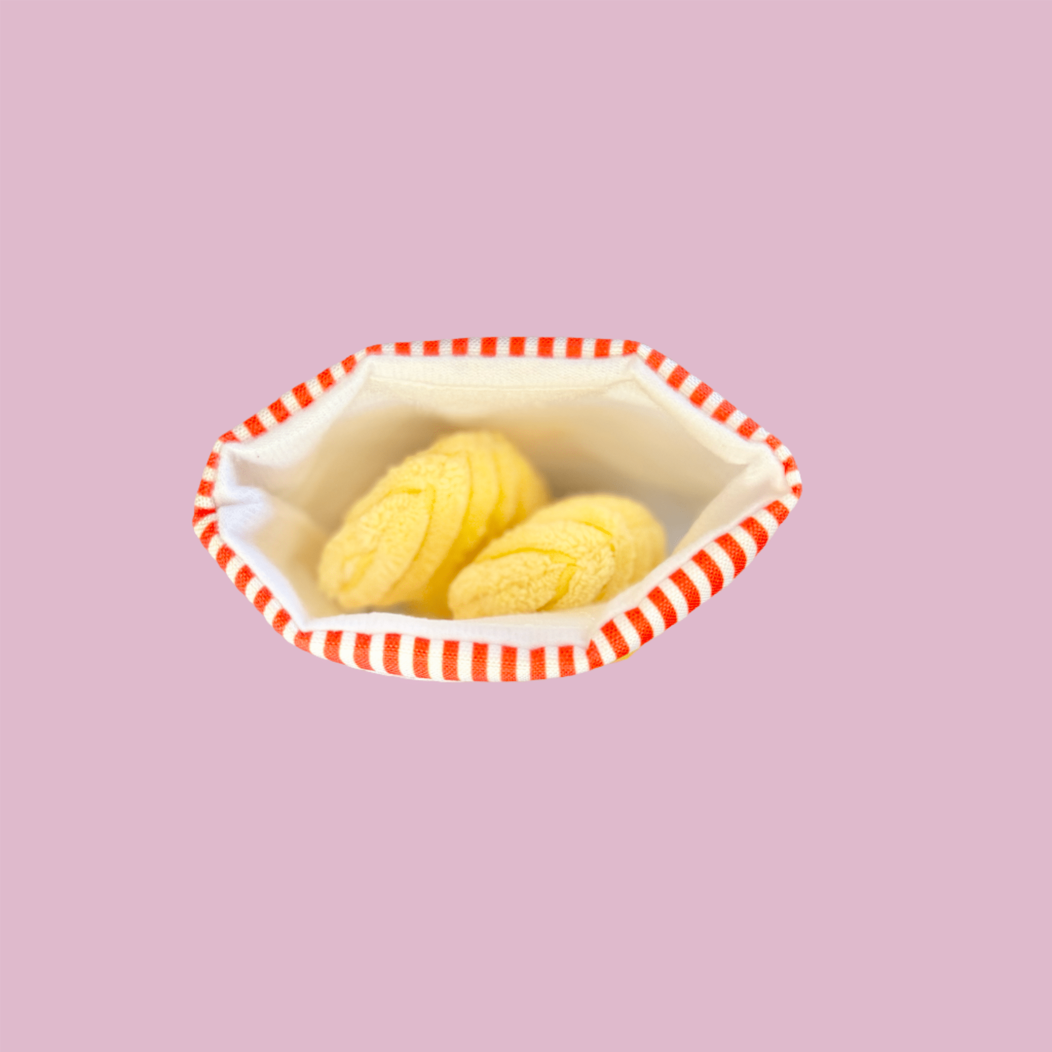 Open plush chip bag dog toy showing yellow snack pieces inside