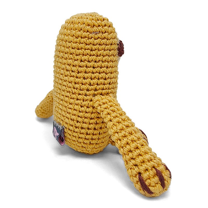 Crocheted sloth plush toy in mustard yellow with beige underside and one visible arm