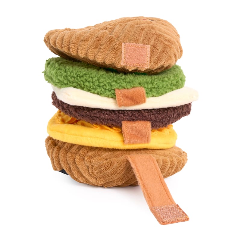 Stacked plush sandwich dog toy with brown bun, green lettuce, white cheese, and yellow filling