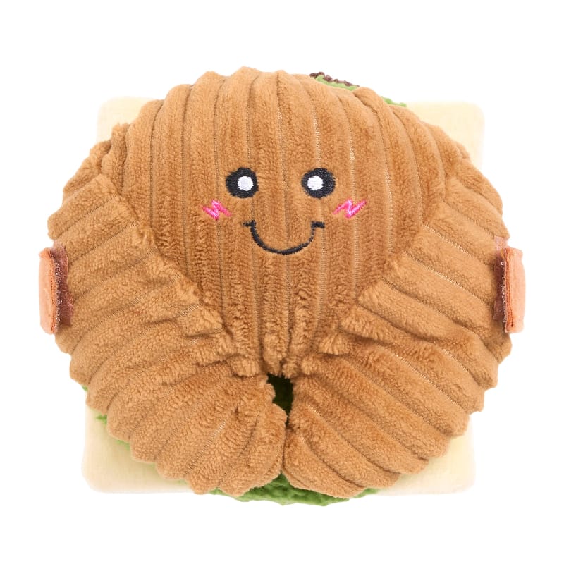 Round plush dog toy face on brown bun with embroidered eyes and small pink accents
